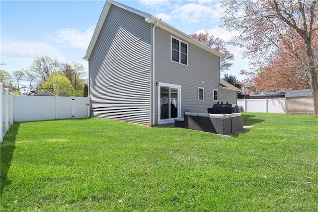 back of house with a yard, outdoor lounge area, and a fenced backyard