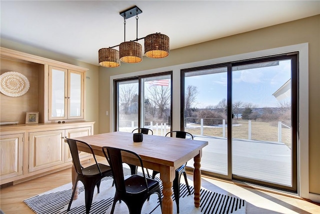 dining space with light wood-type flooring