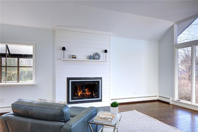 living room with dark wood-style flooring, a fireplace, a baseboard radiator, a baseboard heating unit, and lofted ceiling
