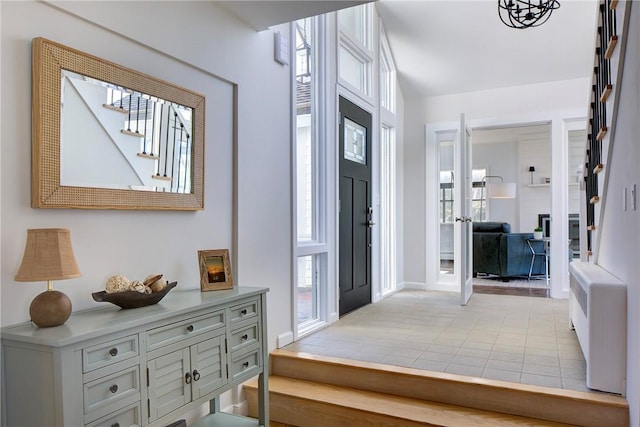 entrance foyer with baseboards and light tile patterned floors