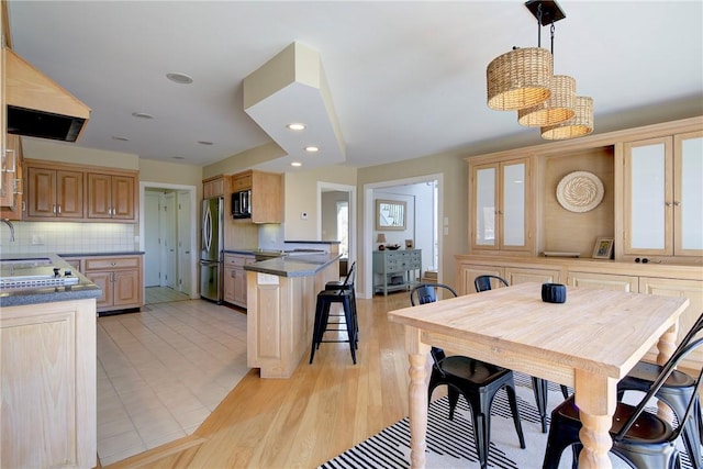 dining room featuring light wood-type flooring and recessed lighting