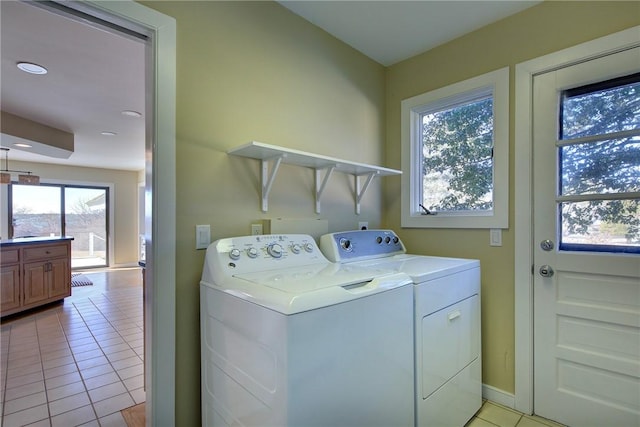 laundry area with independent washer and dryer, laundry area, baseboards, and light tile patterned floors