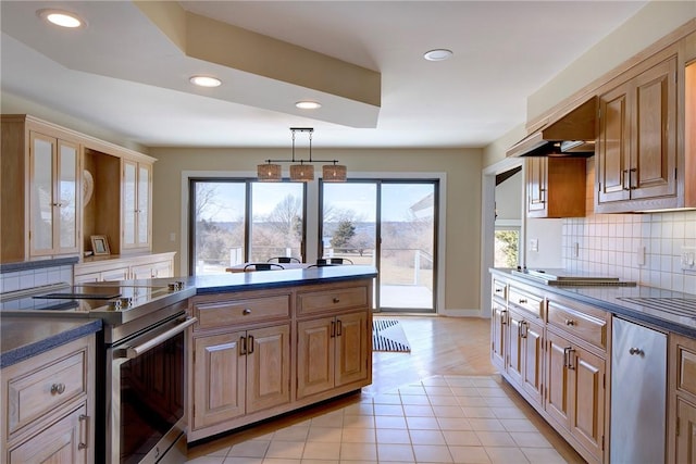 kitchen featuring recessed lighting, dark countertops, backsplash, and stainless steel range with electric cooktop