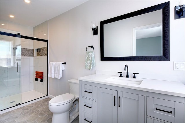 bathroom with vanity, toilet, recessed lighting, baseboards, and a stall shower