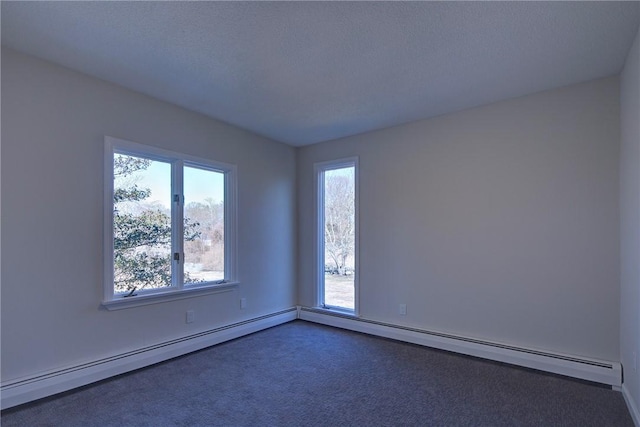 spare room with baseboard heating and dark colored carpet