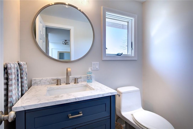 bathroom featuring toilet and vanity