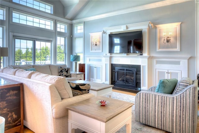living area with crown molding, light wood-style flooring, high vaulted ceiling, and a fireplace