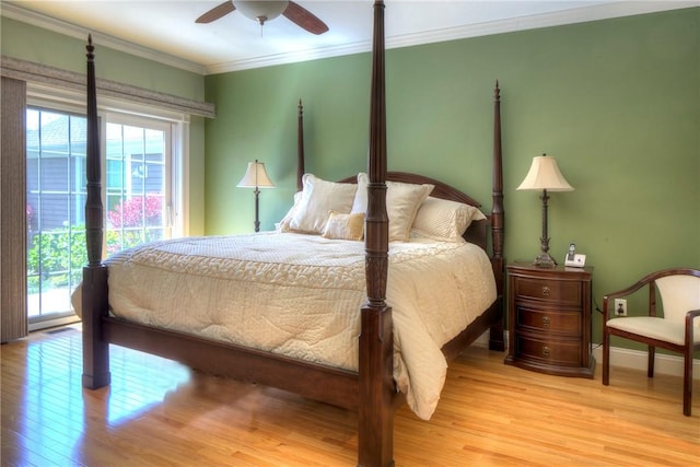 bedroom with crown molding, multiple windows, light wood-style flooring, and access to exterior