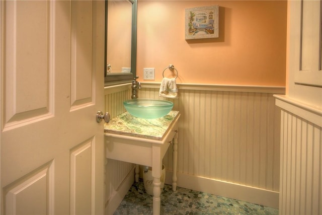 bathroom with wainscoting and a sink