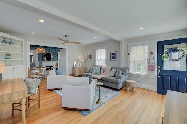 living area featuring recessed lighting, a ceiling fan, and light wood finished floors