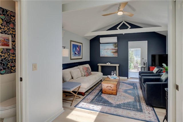 living room with baseboards, ceiling fan, and lofted ceiling