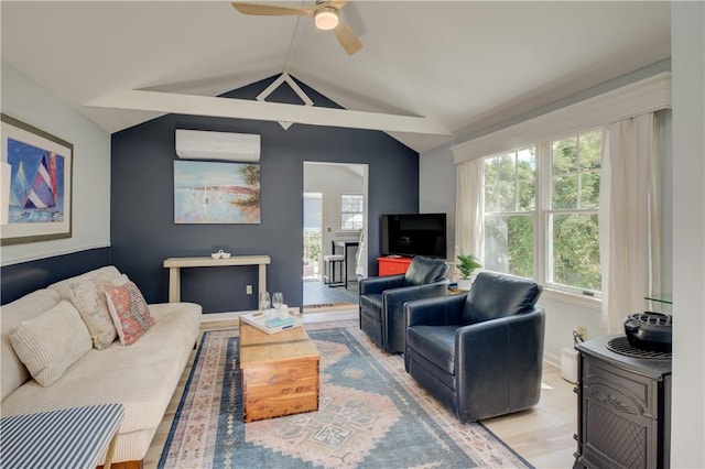 living area with a wall mounted air conditioner, a ceiling fan, wood finished floors, and vaulted ceiling