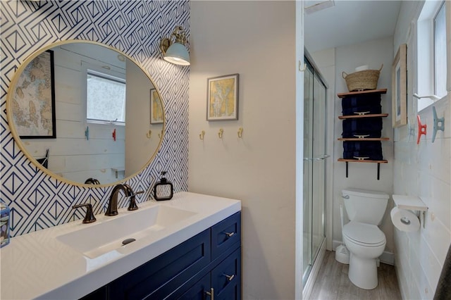 full bathroom featuring vanity, a stall shower, wood finished floors, and toilet
