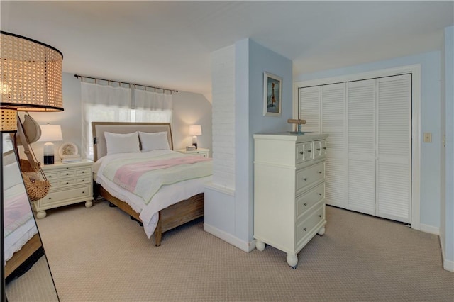 carpeted bedroom with baseboards and a closet