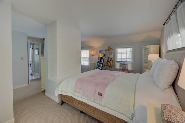 carpeted bedroom featuring baseboards and cooling unit