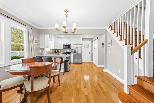 120 Columbia Heights Rd Unit 1, Charlestown, RI 02813 - dining room featuring crown molding, stairway, baseboards, a notable chandelier, and light wood-style flooring