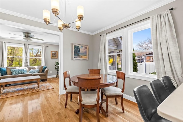 120 Columbia Heights Rd Unit 1, Charlestown, RI 02813 - dining room with baseboards, crown molding, light wood-style floors, and ceiling fan with notable chandelier