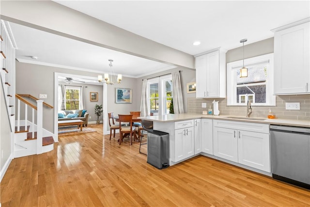 120 Columbia Heights Rd Unit 1, Charlestown, RI 02813 - kitchen featuring stainless steel dishwasher, a sink, light wood finished floors, and light countertops