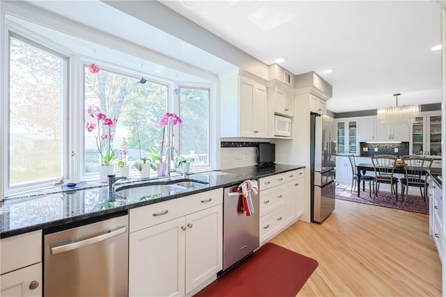 170 Summit Dr, Cranston, RI 02920 - kitchen featuring white cabinetry, light wood finished floors, backsplash, and appliances with stainless steel finishes