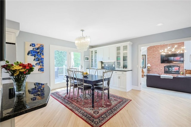 170 Summit Dr, Cranston, RI 02920 - dining space featuring a notable chandelier, baseboards, and light wood-style floors