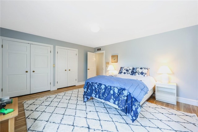 170 Summit Dr, Cranston, RI 02920 - bedroom with visible vents, baseboards, multiple closets, and wood finished floors