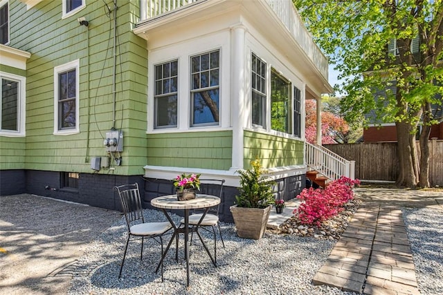 view of property exterior featuring fence and a patio area