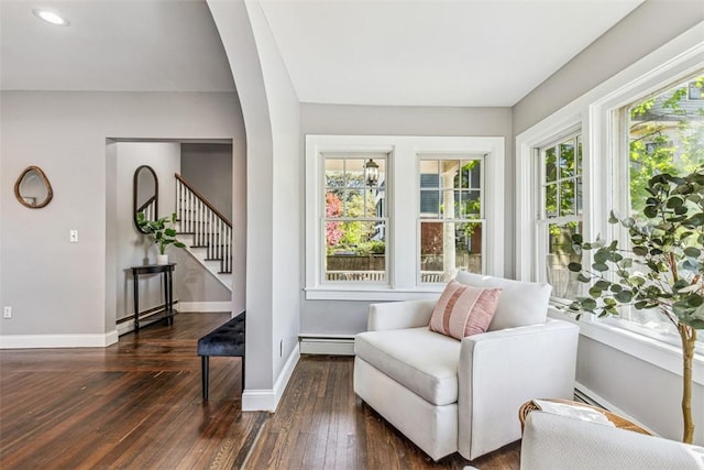 living area featuring dark wood-style flooring, stairs, baseboards, recessed lighting, and a baseboard radiator