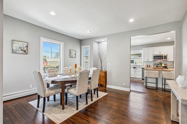 dining area with dark wood-style flooring, recessed lighting, baseboards, and a baseboard radiator