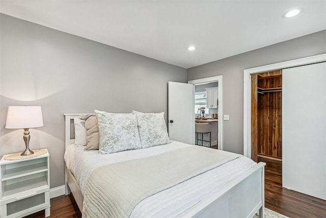 bedroom featuring baseboards, a closet, recessed lighting, and dark wood-type flooring