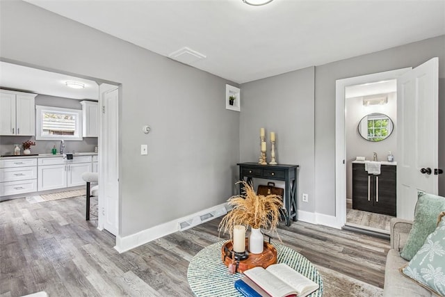 living room with baseboards and light wood-style flooring