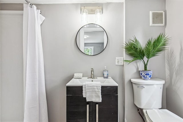 bathroom with visible vents, a shower with curtain, toilet, and vanity