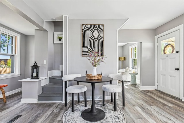 dining room featuring baseboards, wood finished floors, and visible vents