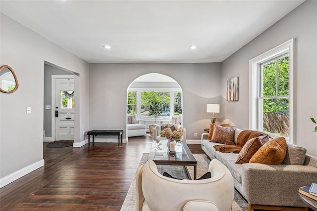 living area with recessed lighting, baseboards, hardwood / wood-style flooring, and a wealth of natural light