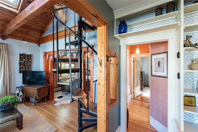 interior space with wood ceiling, lofted ceiling with skylight, and wood finished floors