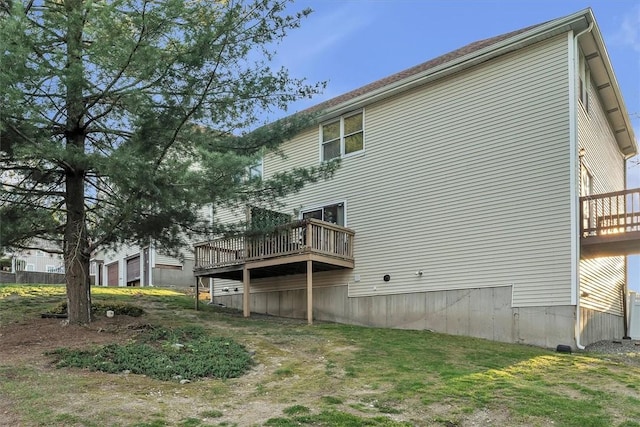 back of property featuring a wooden deck