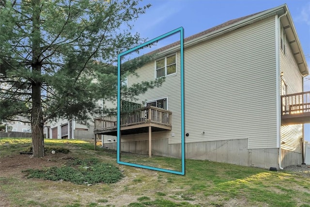 back of house with a deck