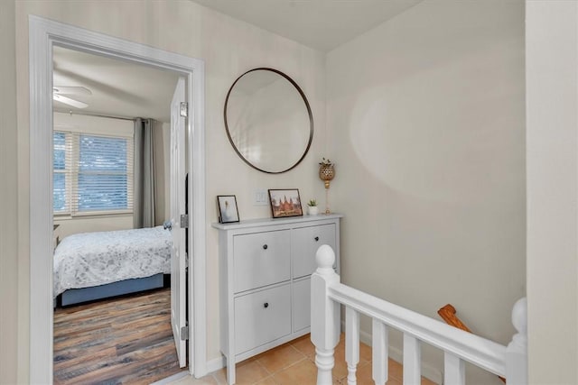 hallway featuring baseboards and light tile patterned floors