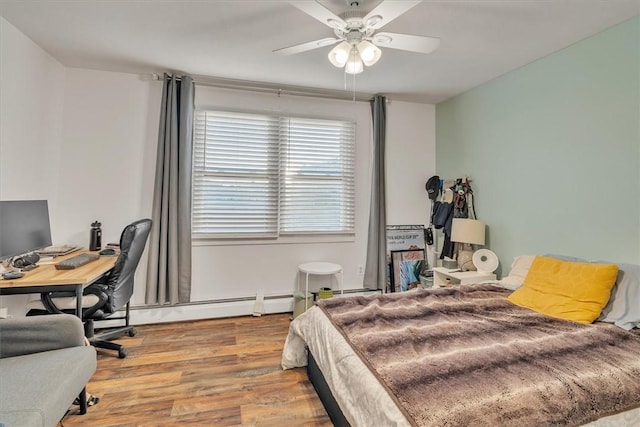 bedroom with a ceiling fan, light wood-style flooring, and a baseboard radiator