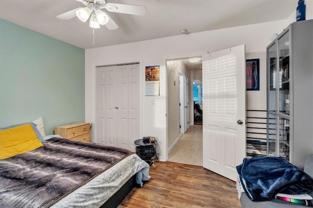bedroom featuring a closet, a ceiling fan, and wood finished floors