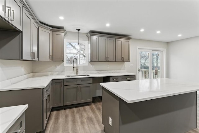 87 Dunedin St, Cranston, RI 02920 - kitchen with gray cabinets, plenty of natural light, and a sink
