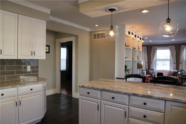 kitchen with visible vents, decorative backsplash, and white cabinets