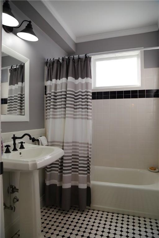 bathroom with shower / bath combination with curtain