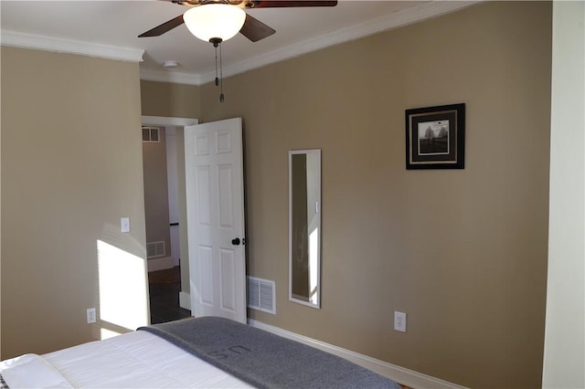 bedroom featuring baseboards, ornamental molding, and visible vents