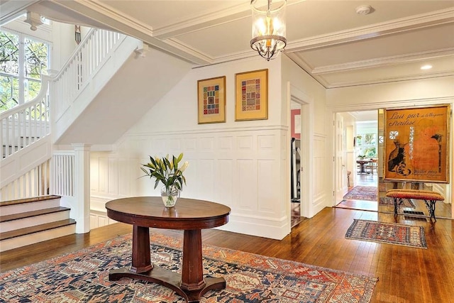 corridor with stairs, dark wood finished floors, and a decorative wall