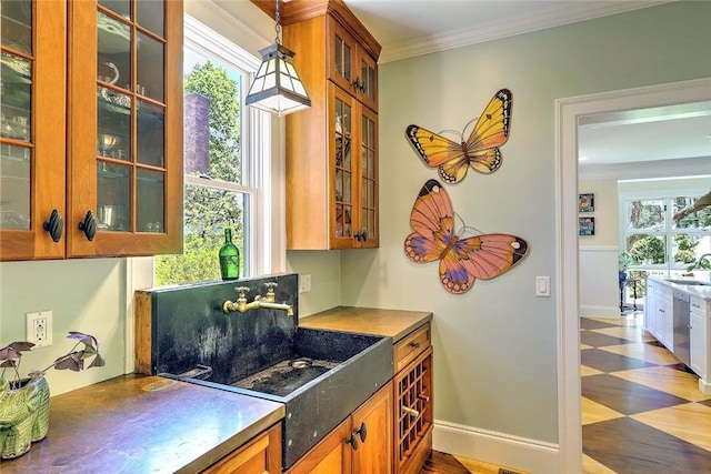 kitchen featuring brown cabinets, a sink, tile patterned floors, stainless steel dishwasher, and glass insert cabinets