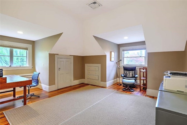 bonus room with baseboards, vaulted ceiling, light wood finished floors, and visible vents
