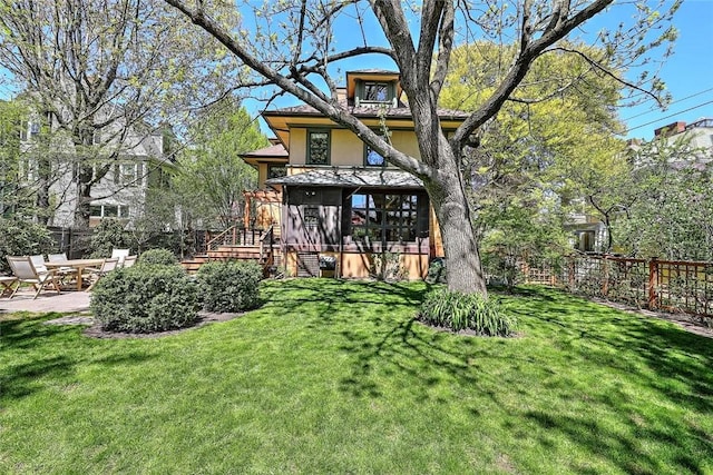 back of property featuring a patio area, stucco siding, a yard, and fence