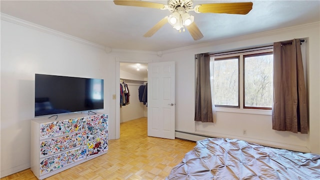 bedroom featuring a closet, a walk in closet, ornamental molding, and a ceiling fan