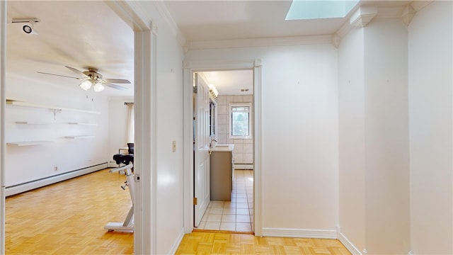 hallway with baseboard heating and a skylight