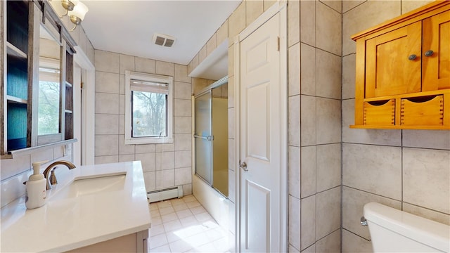 bathroom featuring tile patterned flooring, vanity, toilet, tile walls, and visible vents